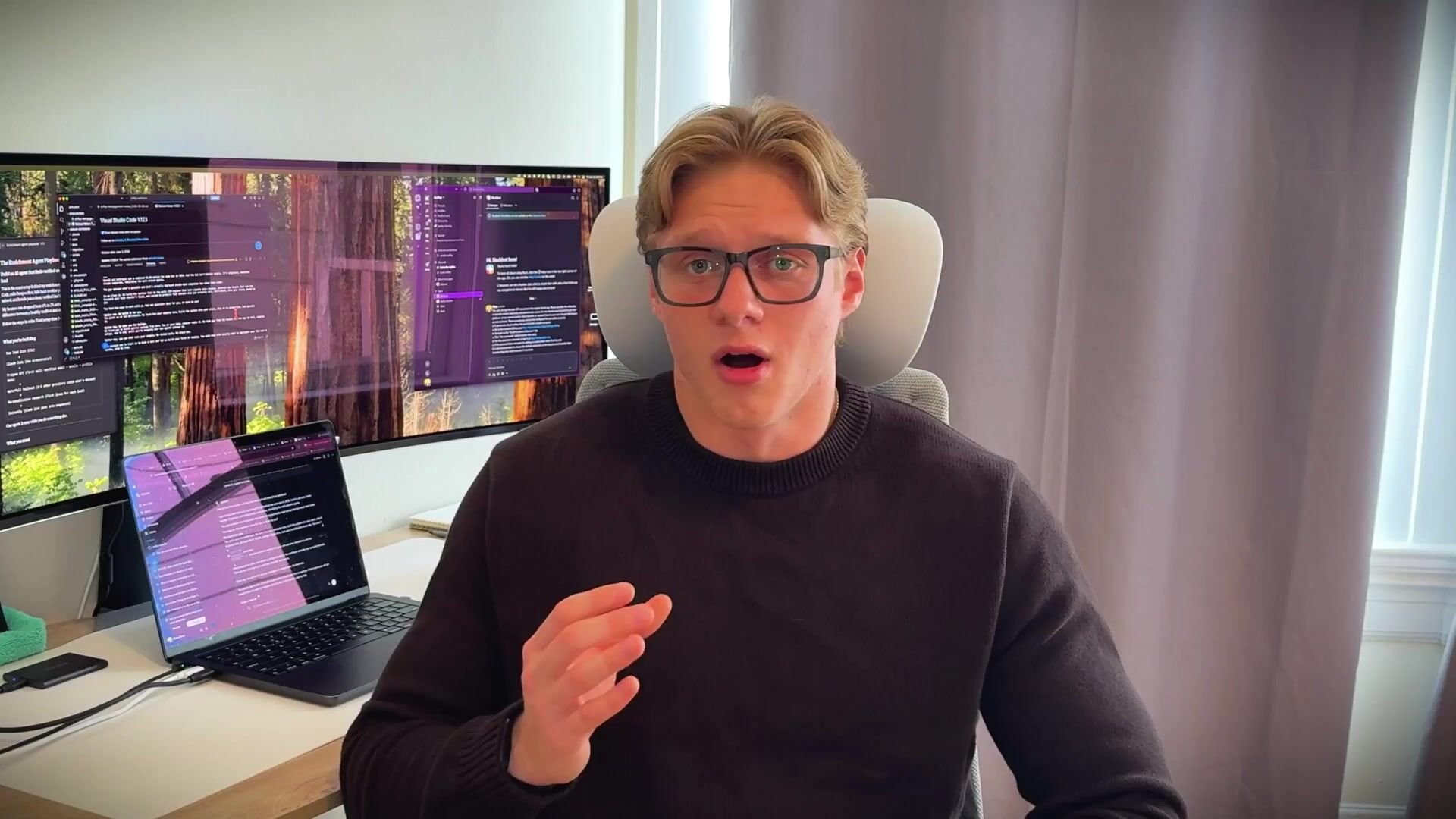 Anfloy founder at his desk with code editors open, explaining how we build custom AI systems for B2B clients